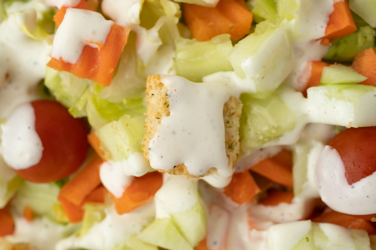 close up overhead shot of crouton topped with Parmesan Peppercorn Dressing