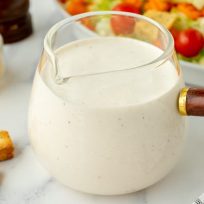 angled shot of creamy dressing in jar