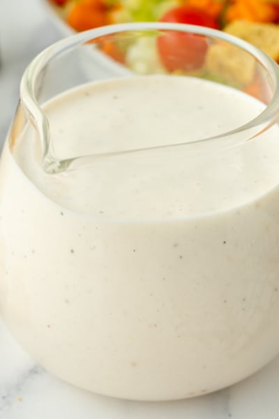 angled shot of creamy dressing in jar