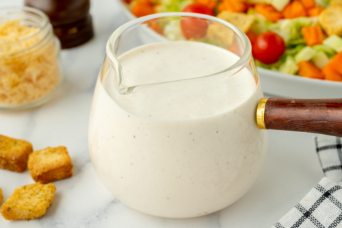 angled shot of creamy dressing in jar