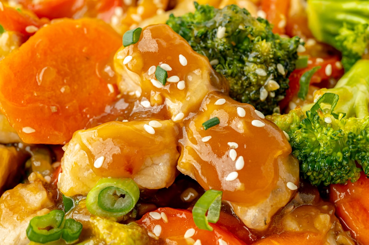 close up shot of pork coated in stir fry sauce