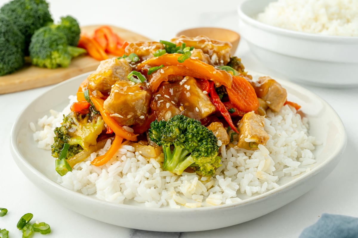 angled shot of rice topped with pork stir fry
