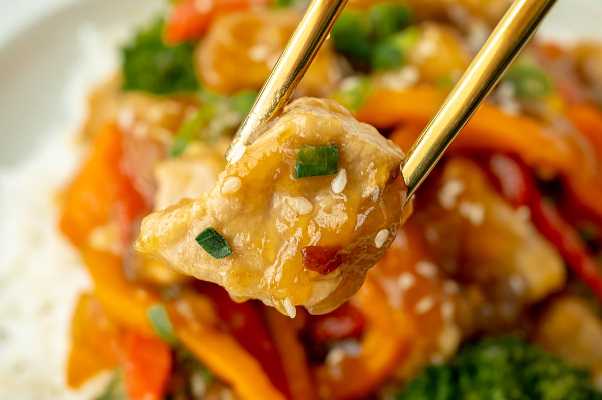 piece of pork in chopsticks