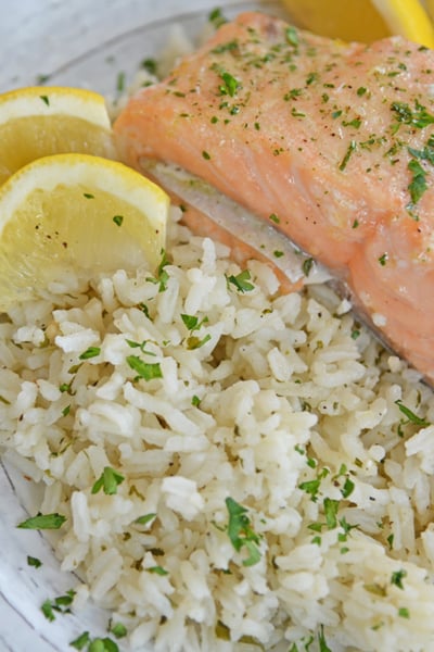 Ranch rice on a plate with lemons and salmon