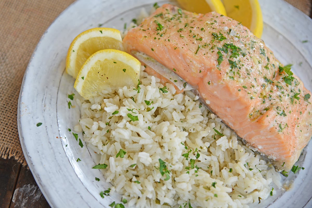 Ranch rice on a plate with lemons and salmon