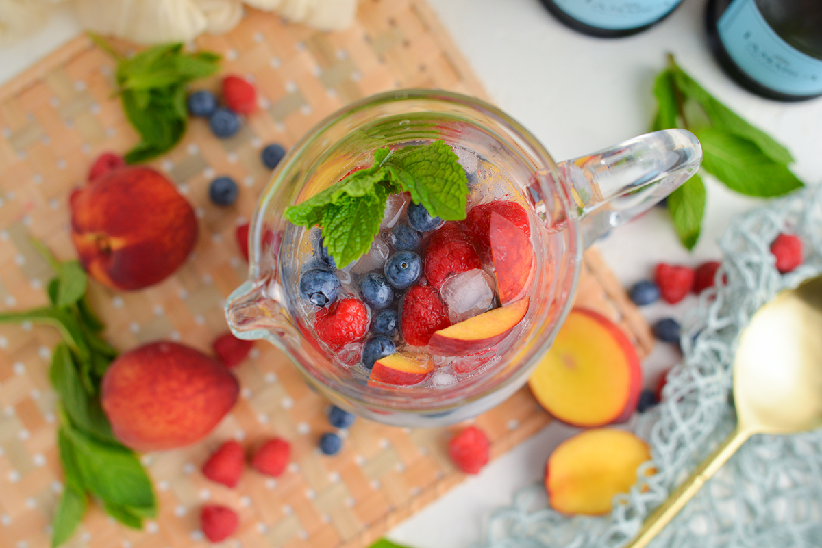 overhead shot of sparkling peach sangria in pitcher