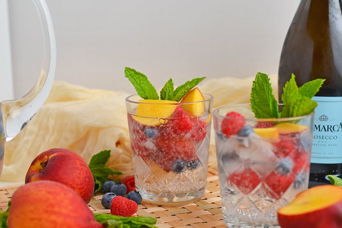 straight on shot of two glasses of sparkling peach sangria