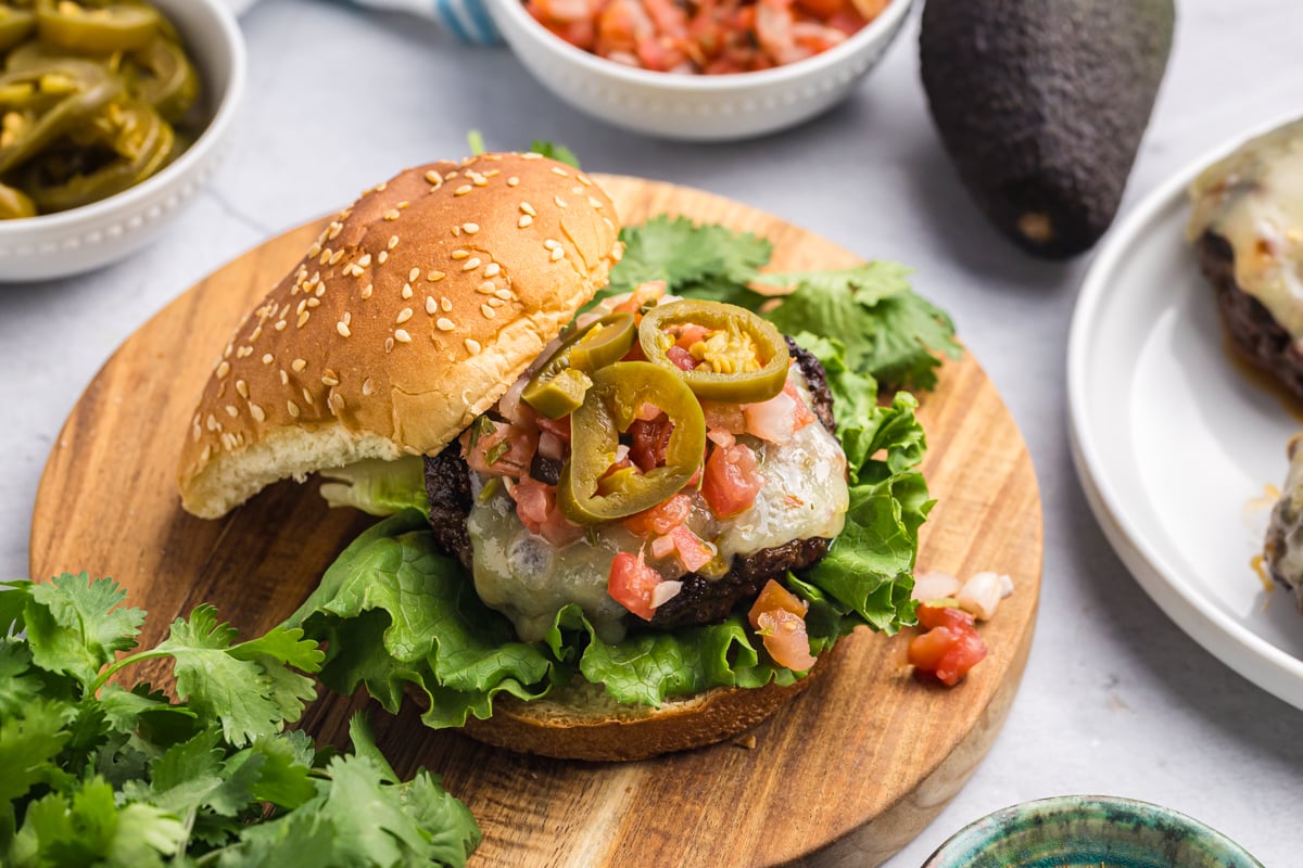 angled shot of taco burger on wooden board