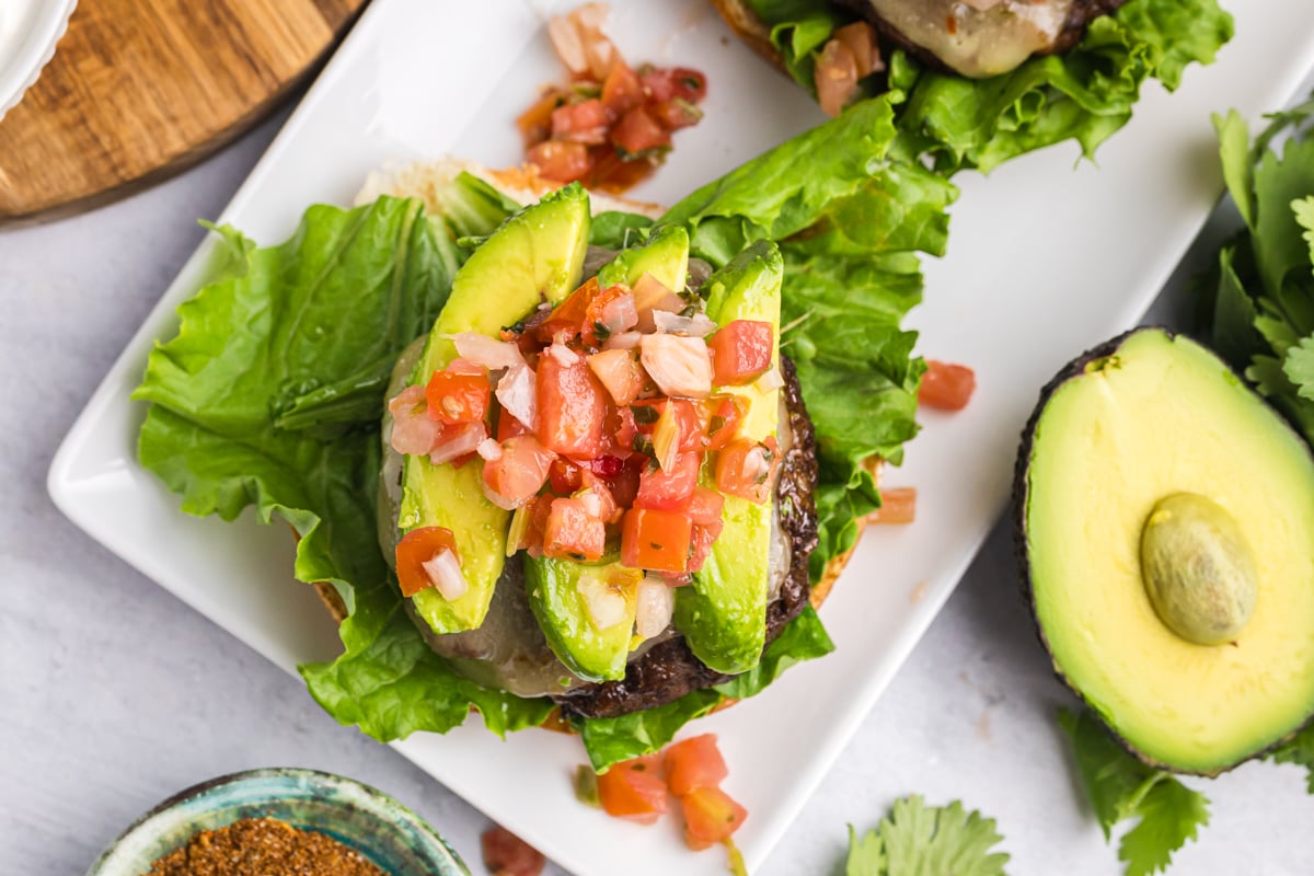 overhead shot of pico de gallo and avocado on a burger