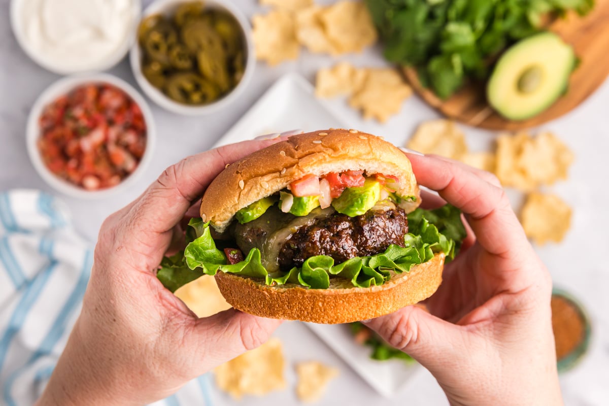 hands holding taco burger