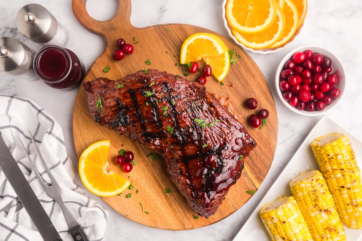 overhead shot of cranberry tri-tip roast on wooden board
