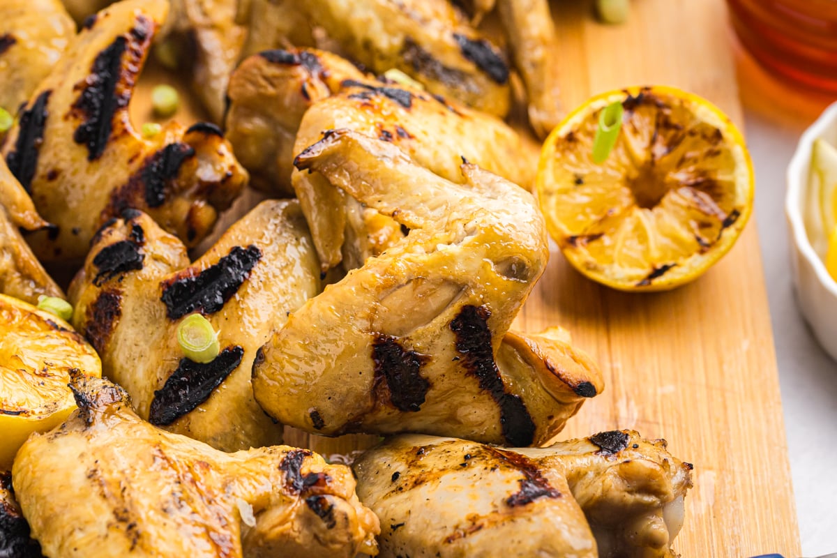 yakitori chicken on wooden board with lemon