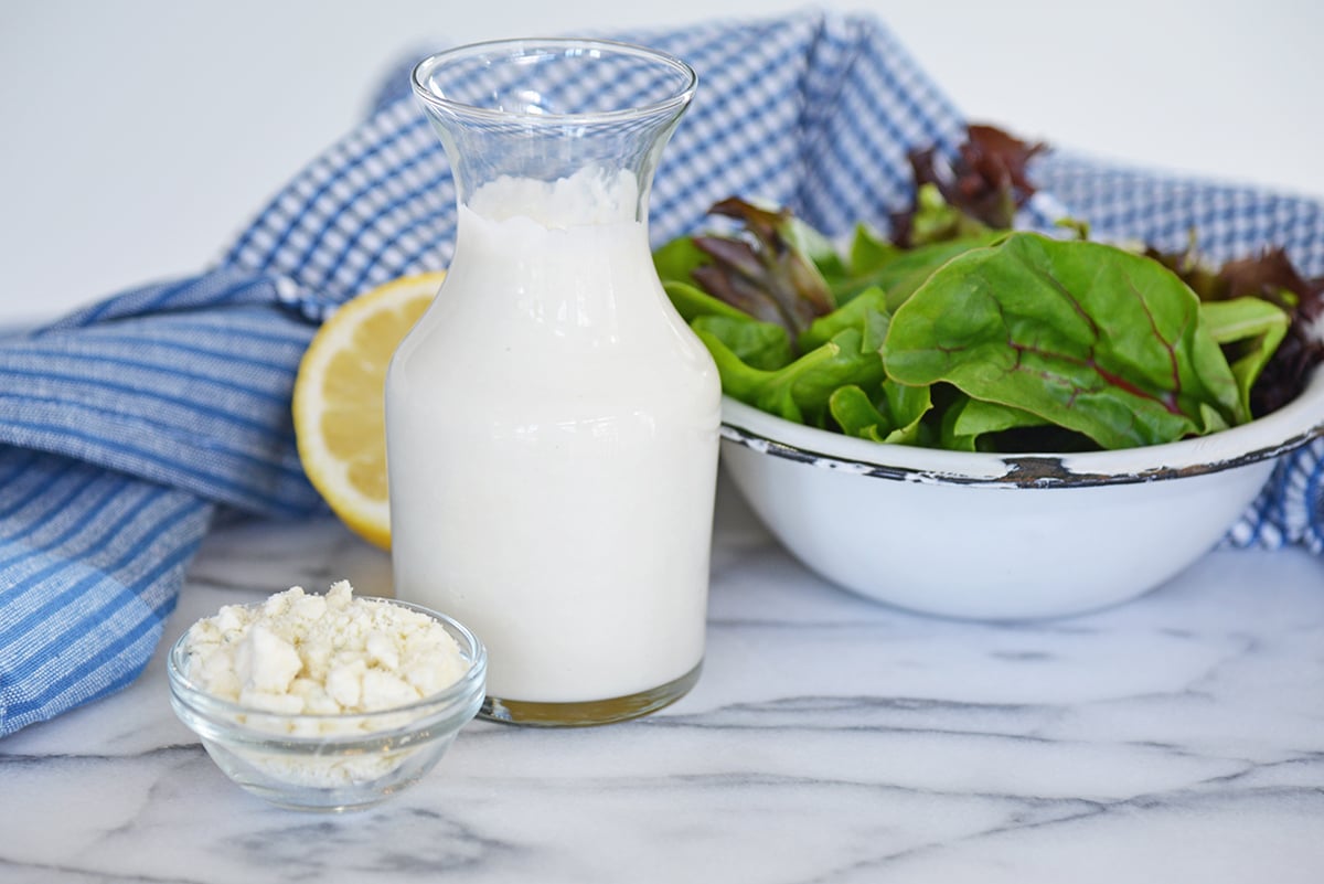 blue cheese in a glass container on a marble slab