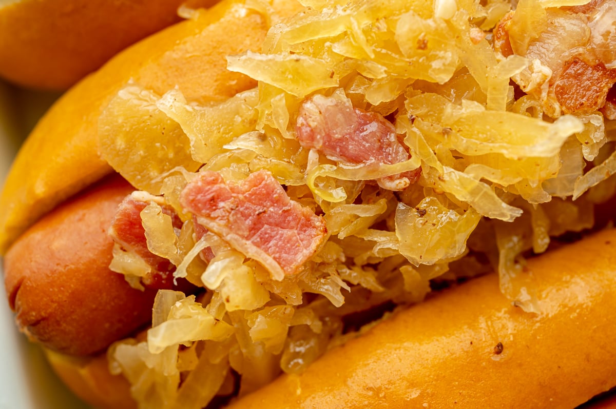 close up shot of sauerkraut on hot dog