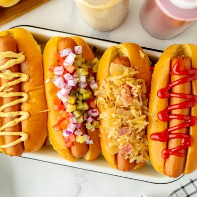 overhead shot of platter of hot dogs with different toppings