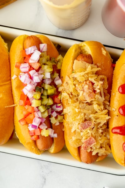 overhead shot of platter of hot dogs with different toppings