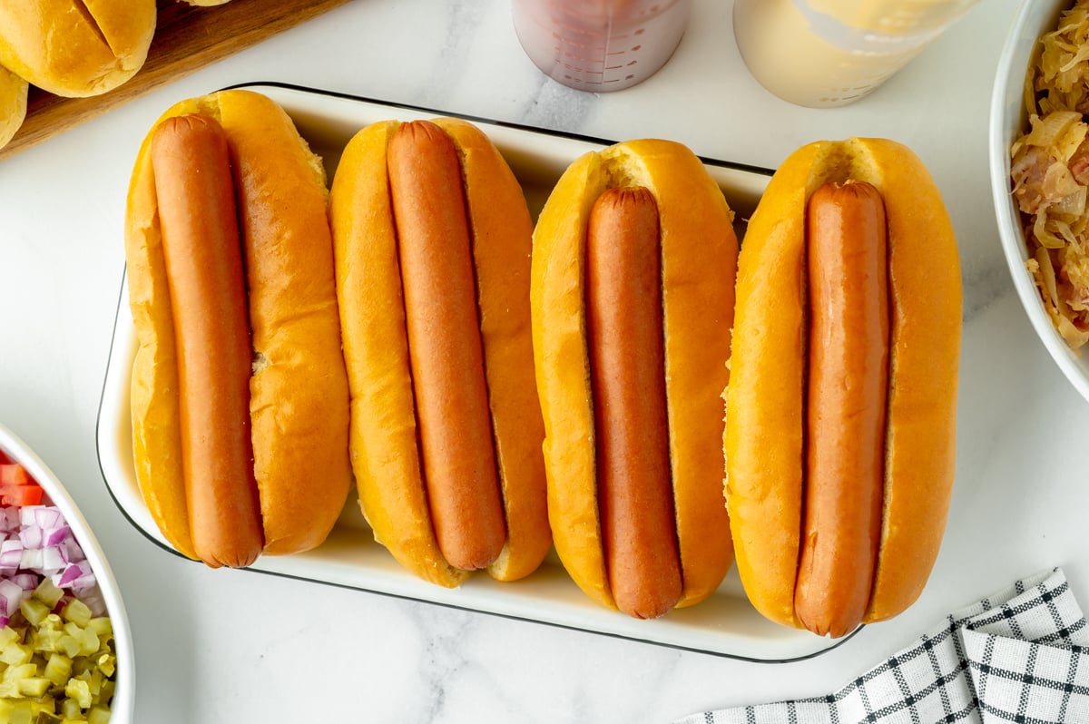 overhead shot of hot dogs in buns on tray