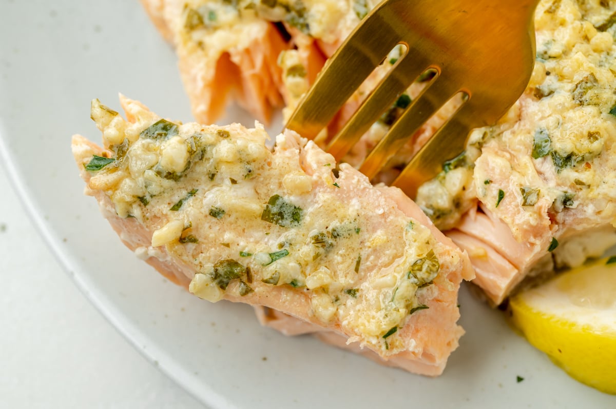 bite of garlic butter salmon on fork