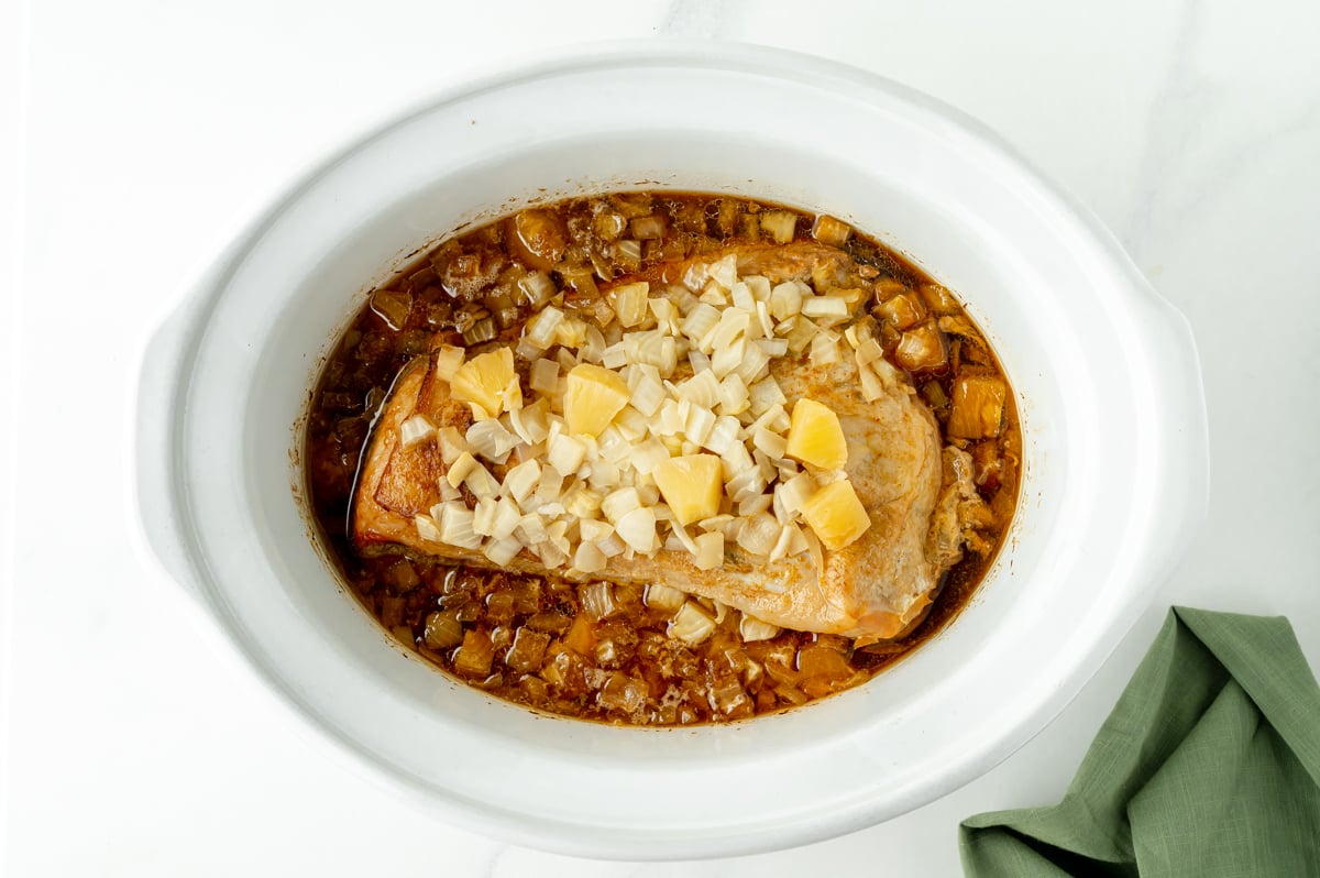 pork loin in the slow cooker with a pineapple soy glaze and onions