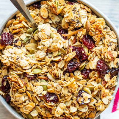 overhead shot of spoon in bowl of granola