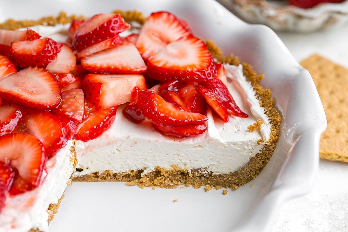 close up of slice taken out of strawberry cream cheese pie