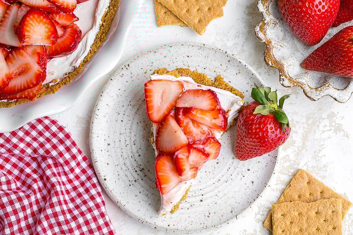 overhead shot of slice of pie on plate with strawberry