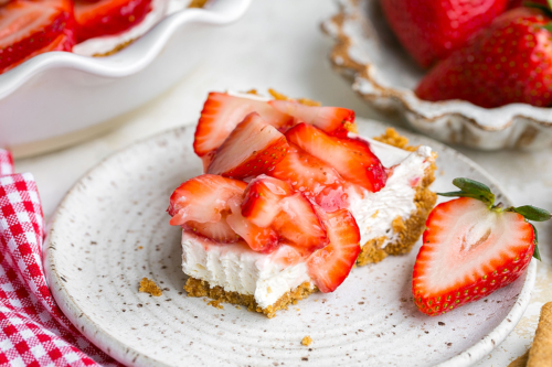 bite taken out of slice of strawberry pie on plate