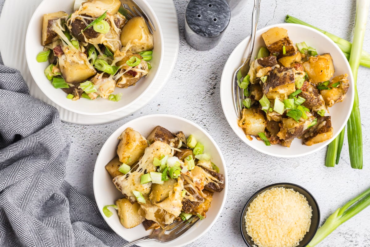 overhead shot of three bowls of cheesy potatoes