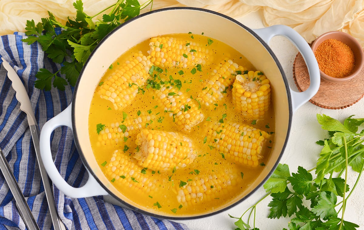 overhead shot of corn on the cob boiling in pot