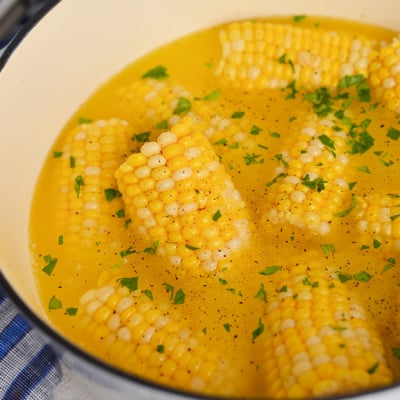 angled shot of boiling pot of corn on the cob
