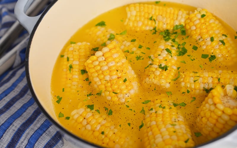 angled shot of boiling pot of corn on the cob