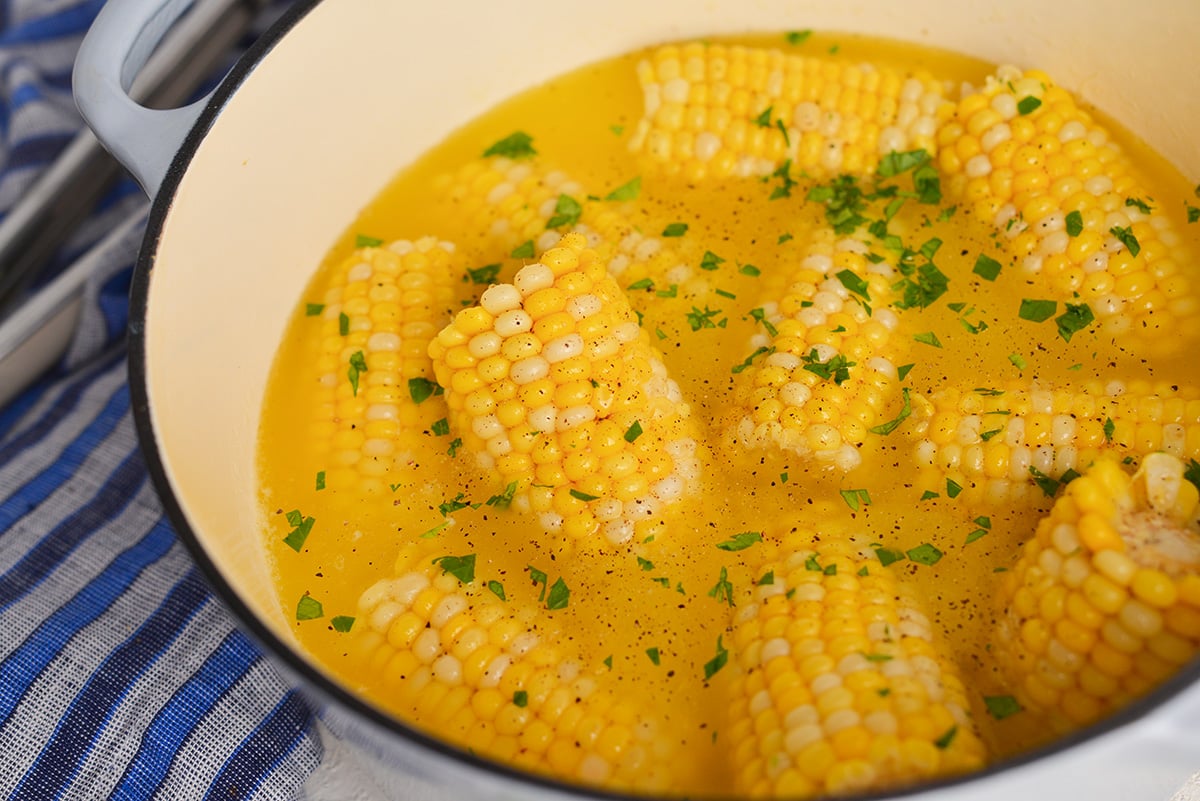 angled shot of boiling pot of corn on the cob