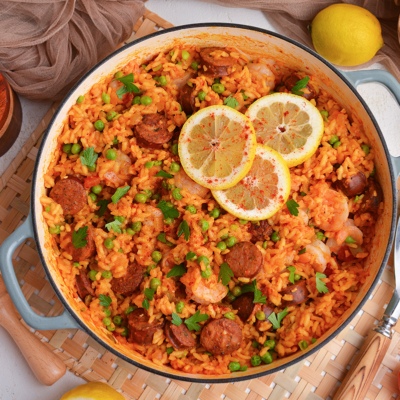 overhead shot of pan of shrimp paella with lemon slices