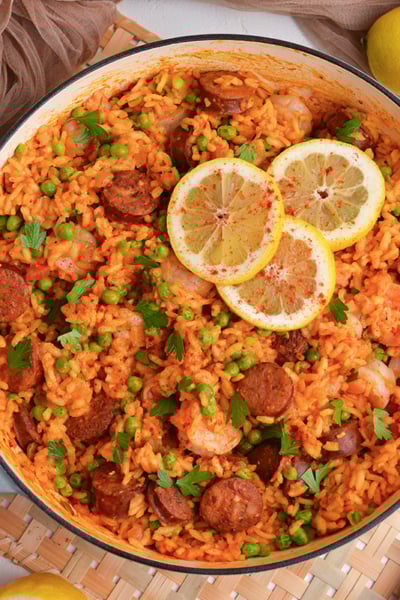 overhead shot of pan of shrimp paella with lemon slices