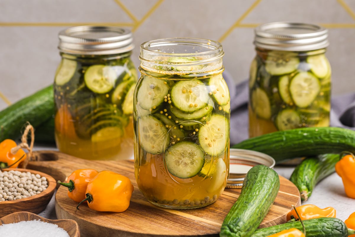 jar of spicy pickles on wooden board