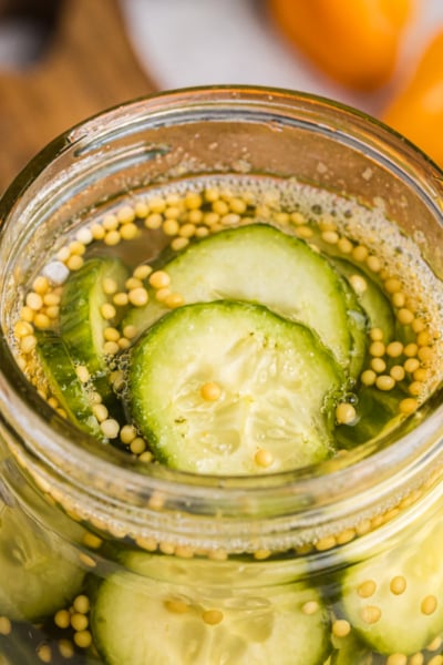angled close up shot of jar of spicy pickles