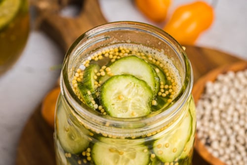 angled close up shot of jar of spicy pickles
