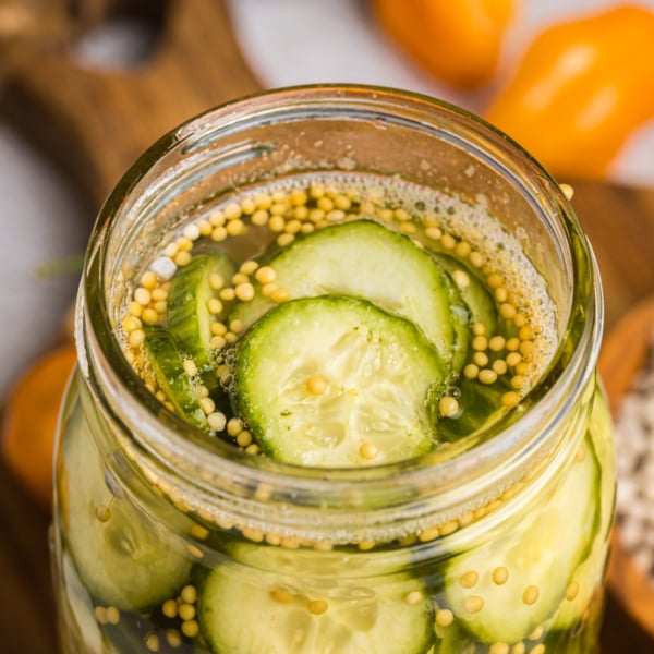 angled close up shot of jar of spicy pickles