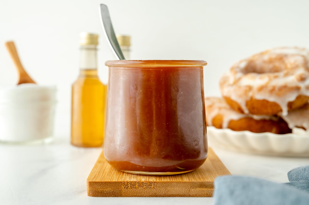 straight on shot of jar of bourbon caramel sauce with spoon in it