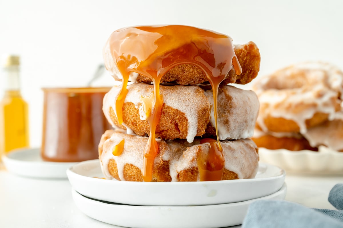 straight on shot of plate of donuts dripping with caramel