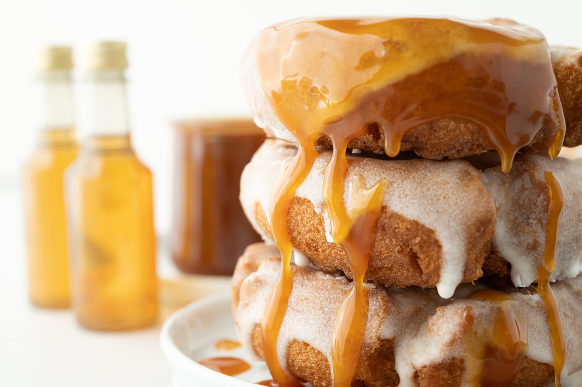 close up shot of stack of donuts drizzled with caramel