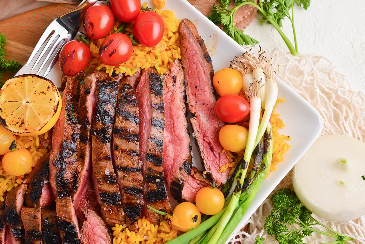 overhead shot of sliced carne asada on platter