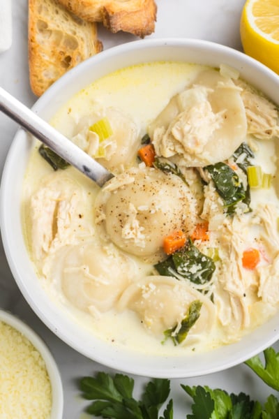 overhead shot of spoon in bowl of chicken florentine soup