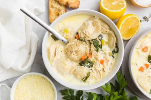overhead shot of spoon in bowl of chicken florentine soup