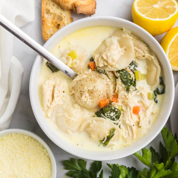 overhead shot of spoon in bowl of chicken florentine soup