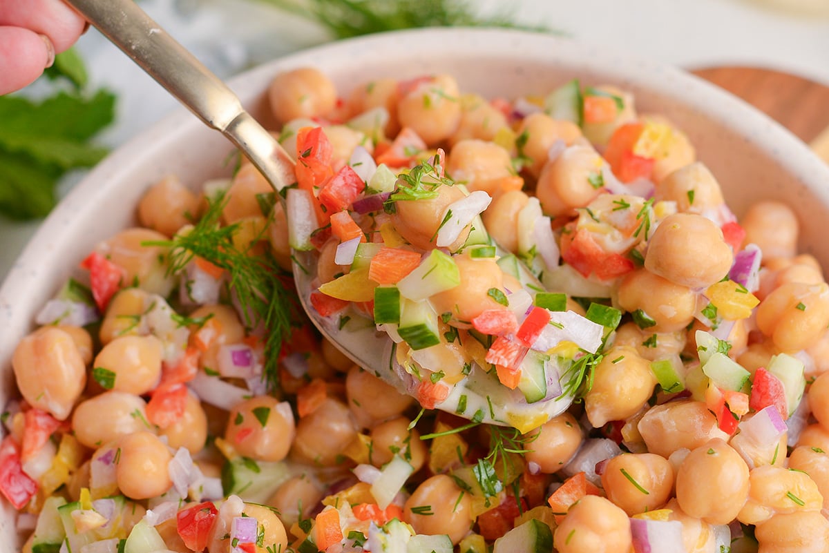 spoon in bowl of chickpeas and veggies