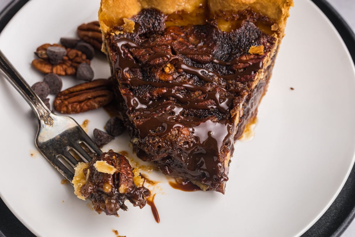 close up of bite taken out of slice of pie by fork