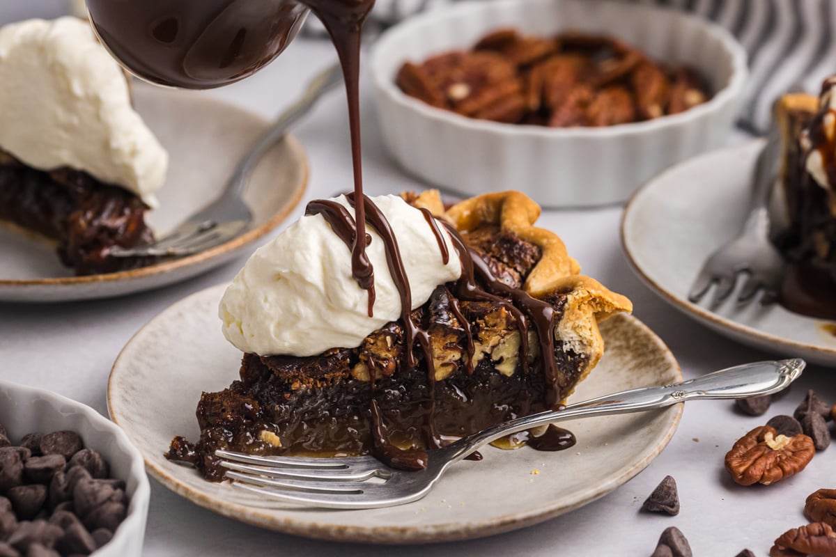 warm chocolate fudge poured over slice of chocolate pecan pie