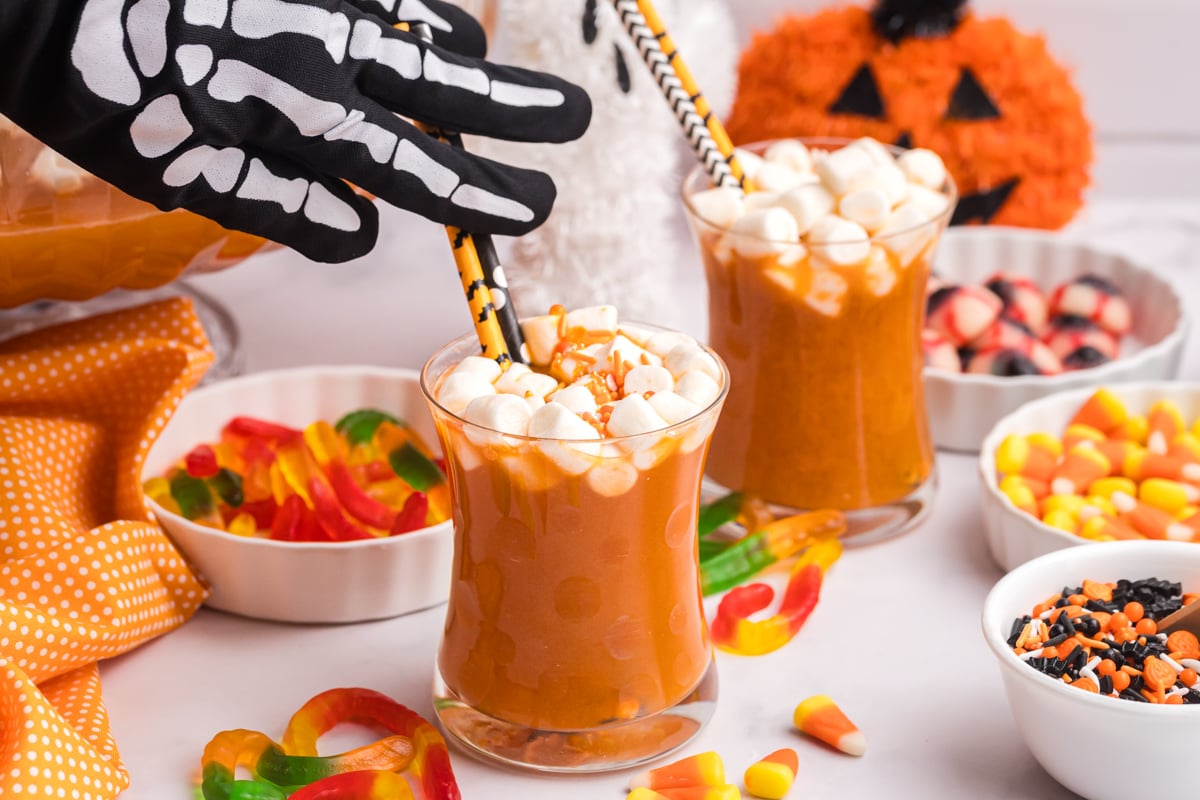 spooky hand mixing halloween punch