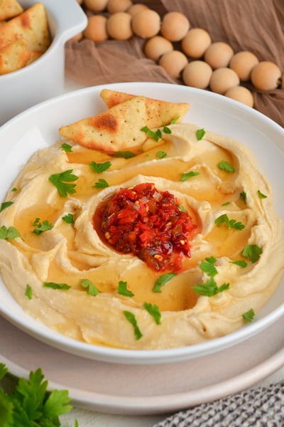 angled shot of bowl of hot honey hummus